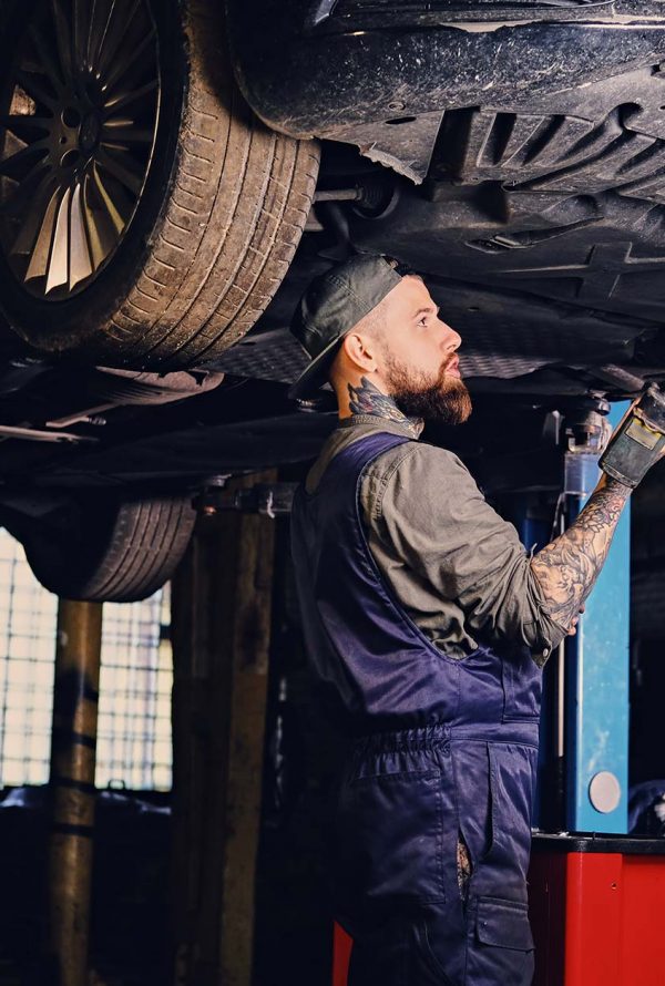 bearded-mechanic-working-with-the-cars-chassis-in-small
