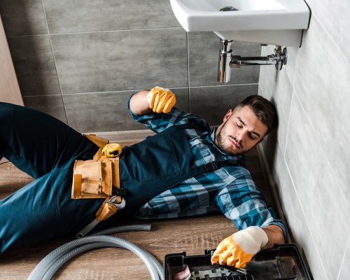 bearded-handyman-lying-on-floor-near-toolbox-in-ba-resize