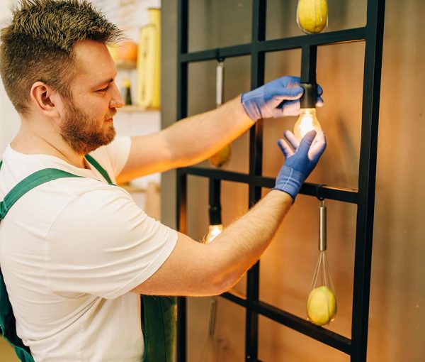 electrician-changes-the-light-bulb-handyman-resize