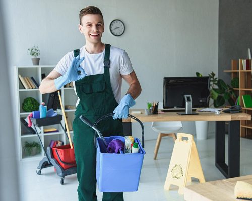 handsome-smiling-young-cleaner-holding-bucket-with-resize
