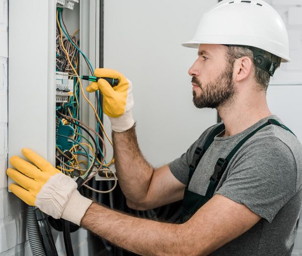 side-view-of-handsome-bearded-electrician-repairin-resize