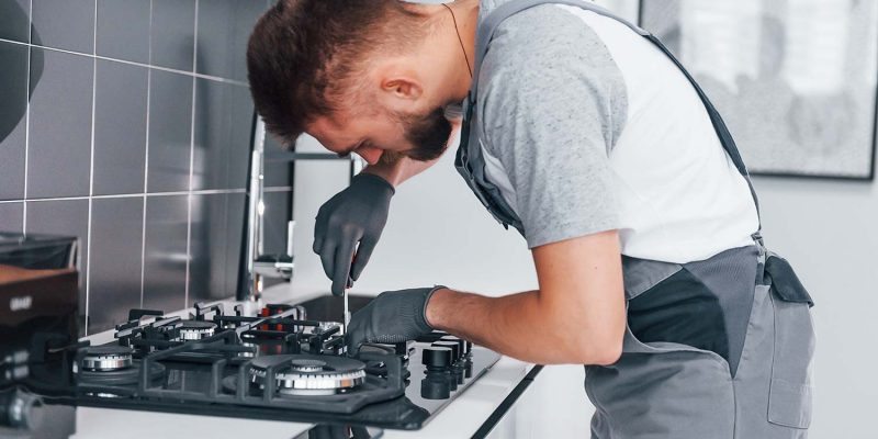 young-professional-plumber-in-grey-uniform-working-resize