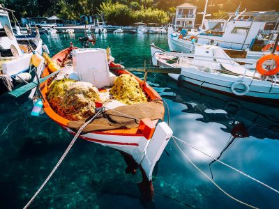 colorful-greek-fishing-boats-in-small-port-harbor-resize