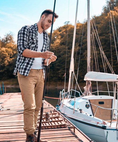 young-man-preparing-his-fishing-rod-MTH5KA6-resize